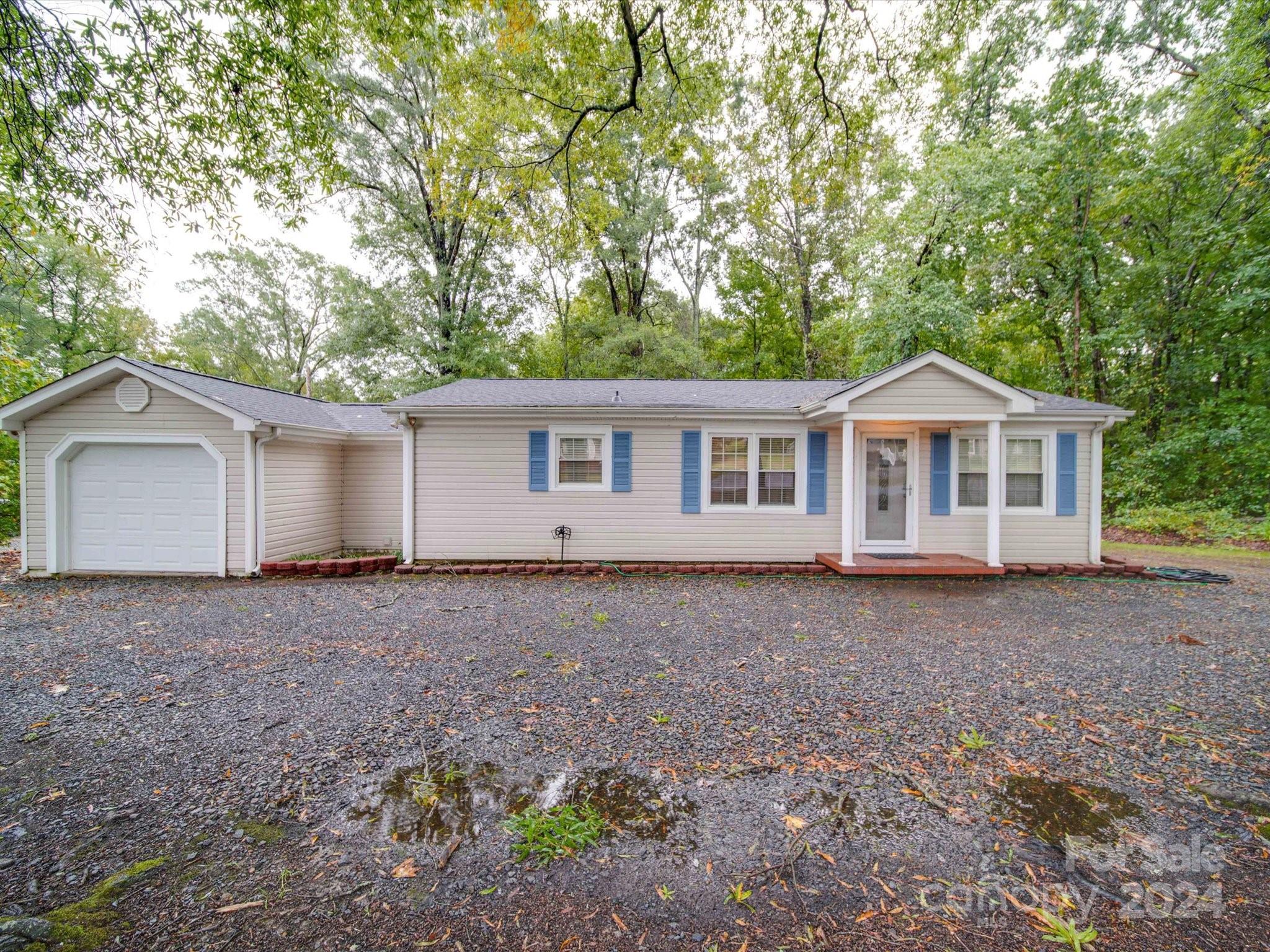 a view of house with a backyard
