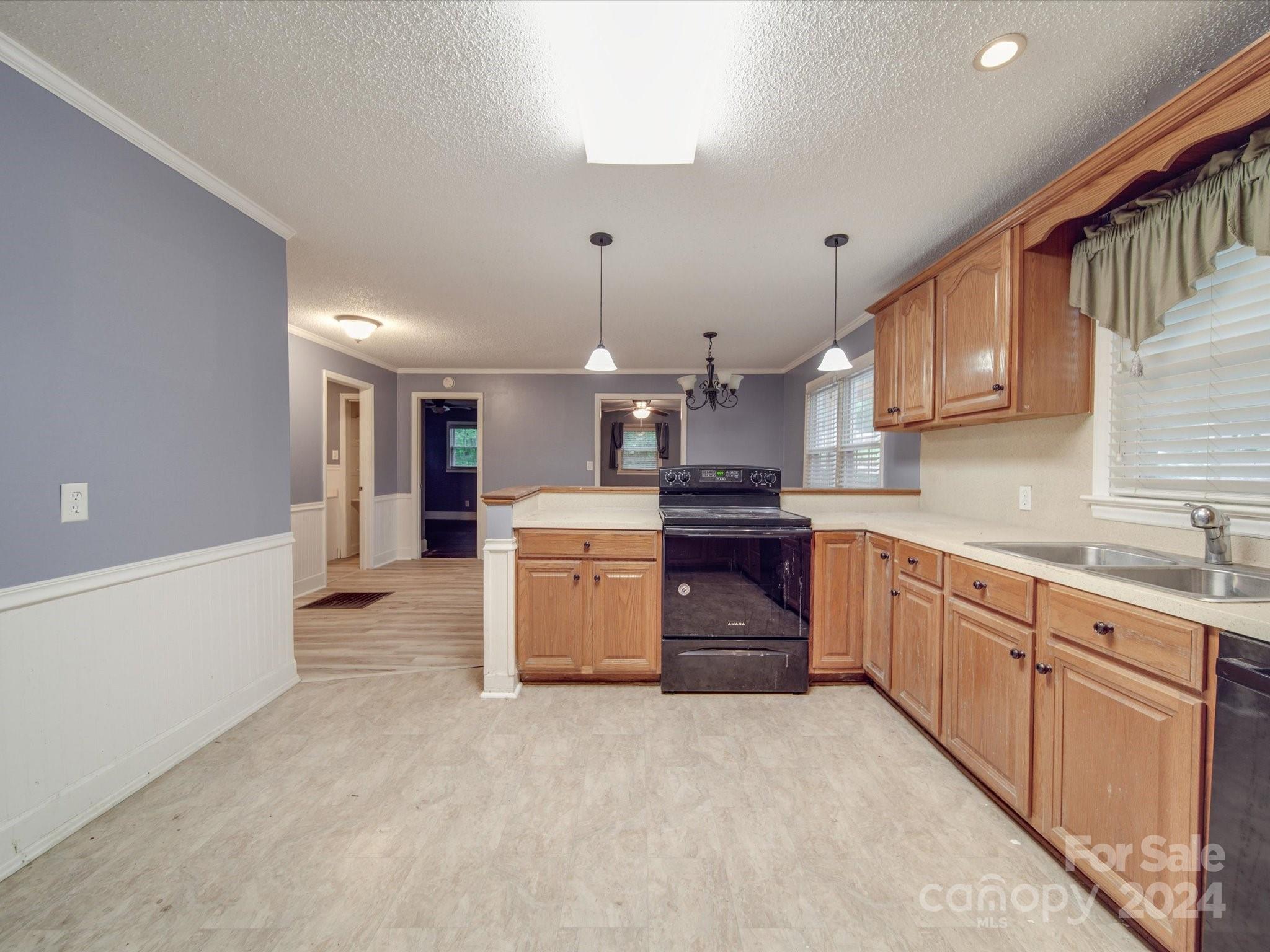 20082 Coley Store Road Locust, NC 28097 - Photo 12 of 43 a large kitchen with stainless steel appliances kitchen island granite countertop a sink and cabinets