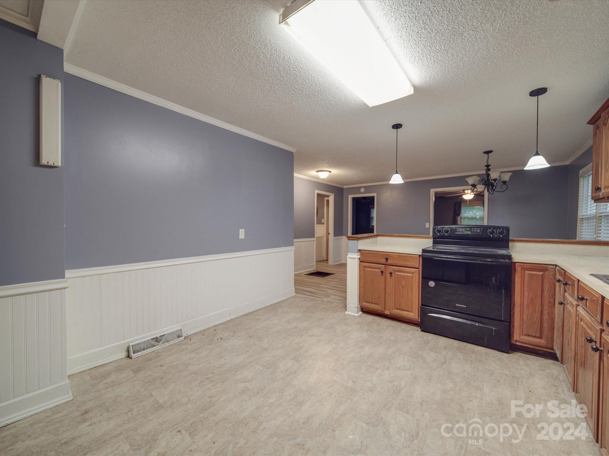 20082 Coley Store Road Locust, NC 28097 - Photo 13 of 43 a large white kitchen with a stove a sink and a refrigerator