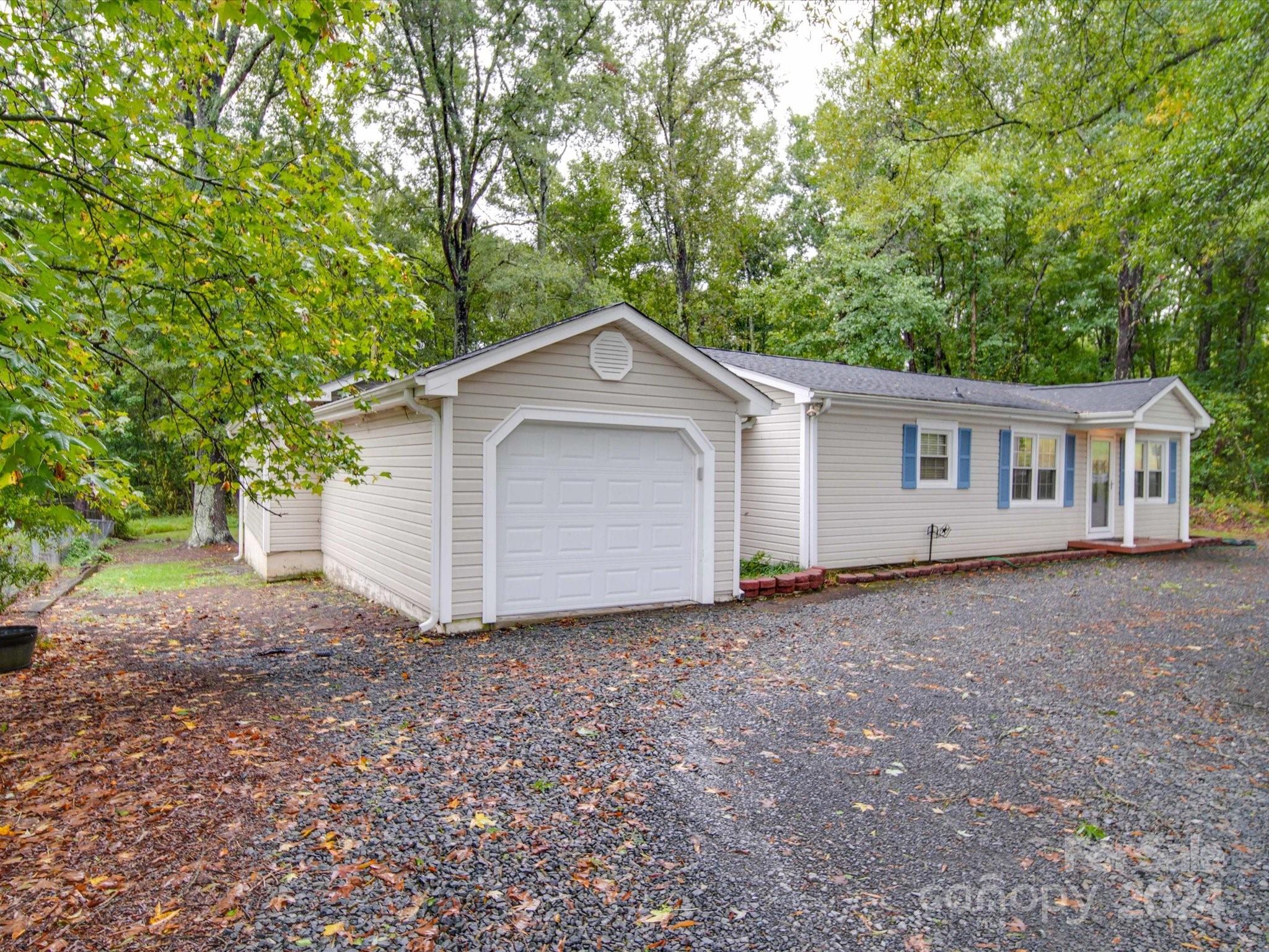 20082 Coley Store Road Locust, NC 28097 - Photo 2 of 43 a view of a house with a yard and large trees