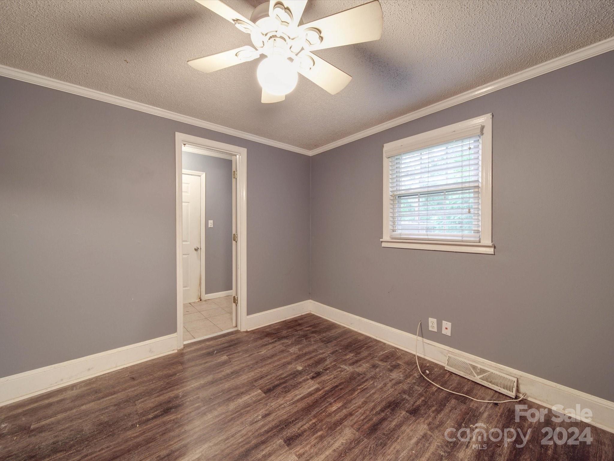 20082 Coley Store Road Locust, NC 28097 - Photo 22 of 43 a view of an empty room with wooden floor and a window