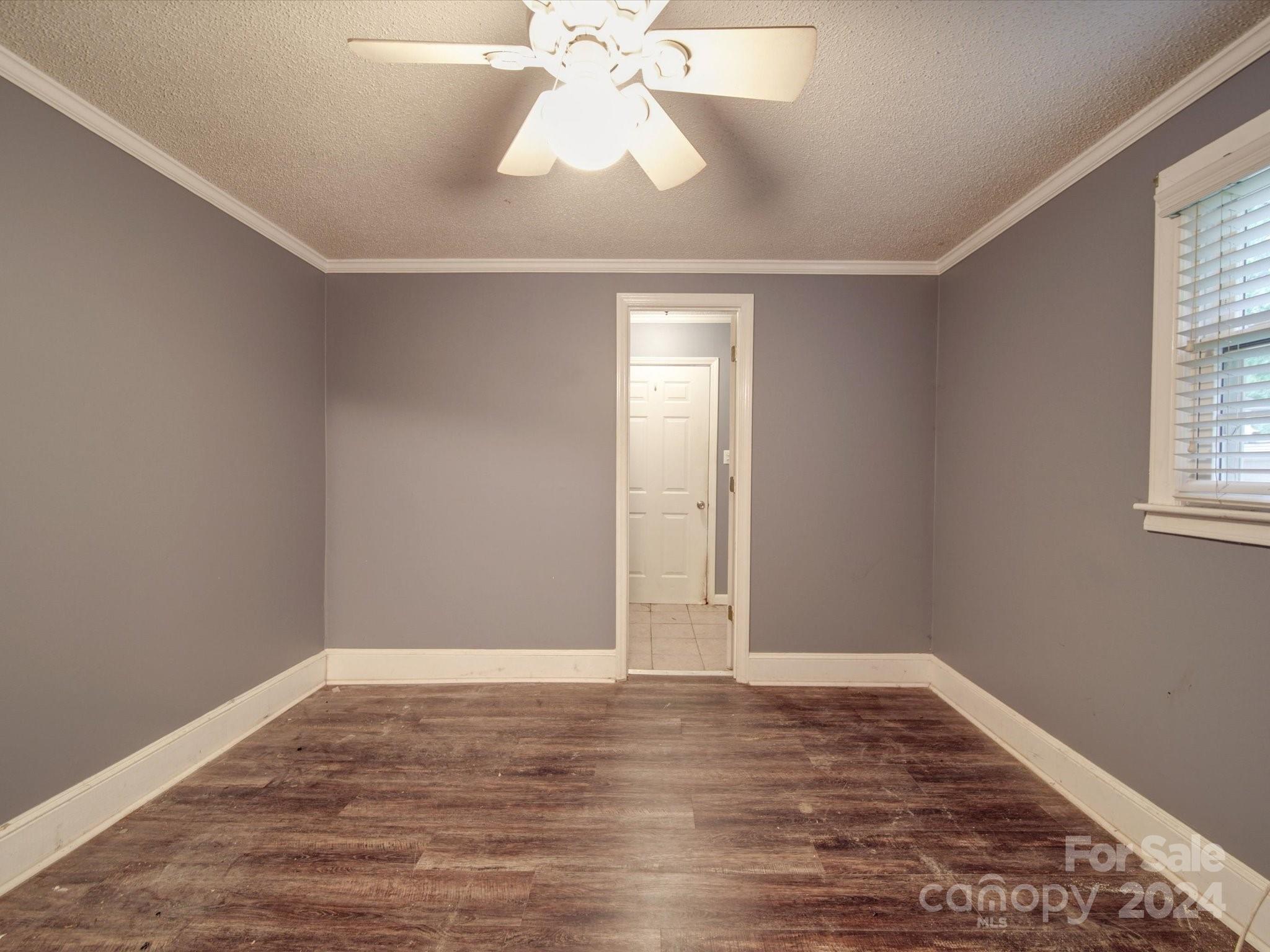 20082 Coley Store Road Locust, NC 28097 - Photo 23 of 43 an empty room with wooden floor fan and windows
