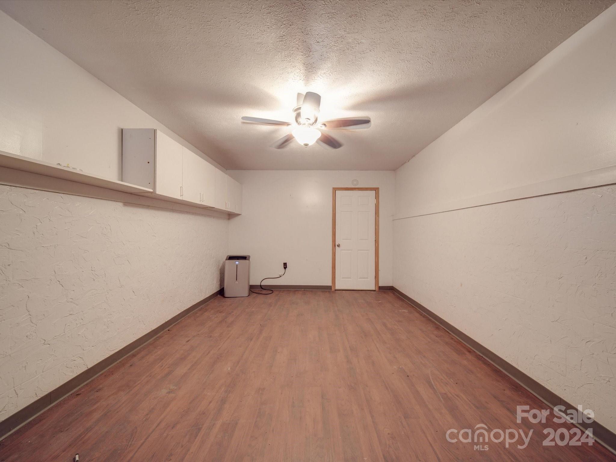 20082 Coley Store Road Locust, NC 28097 - Photo 28 of 43 an empty room with chandelier fan and windows