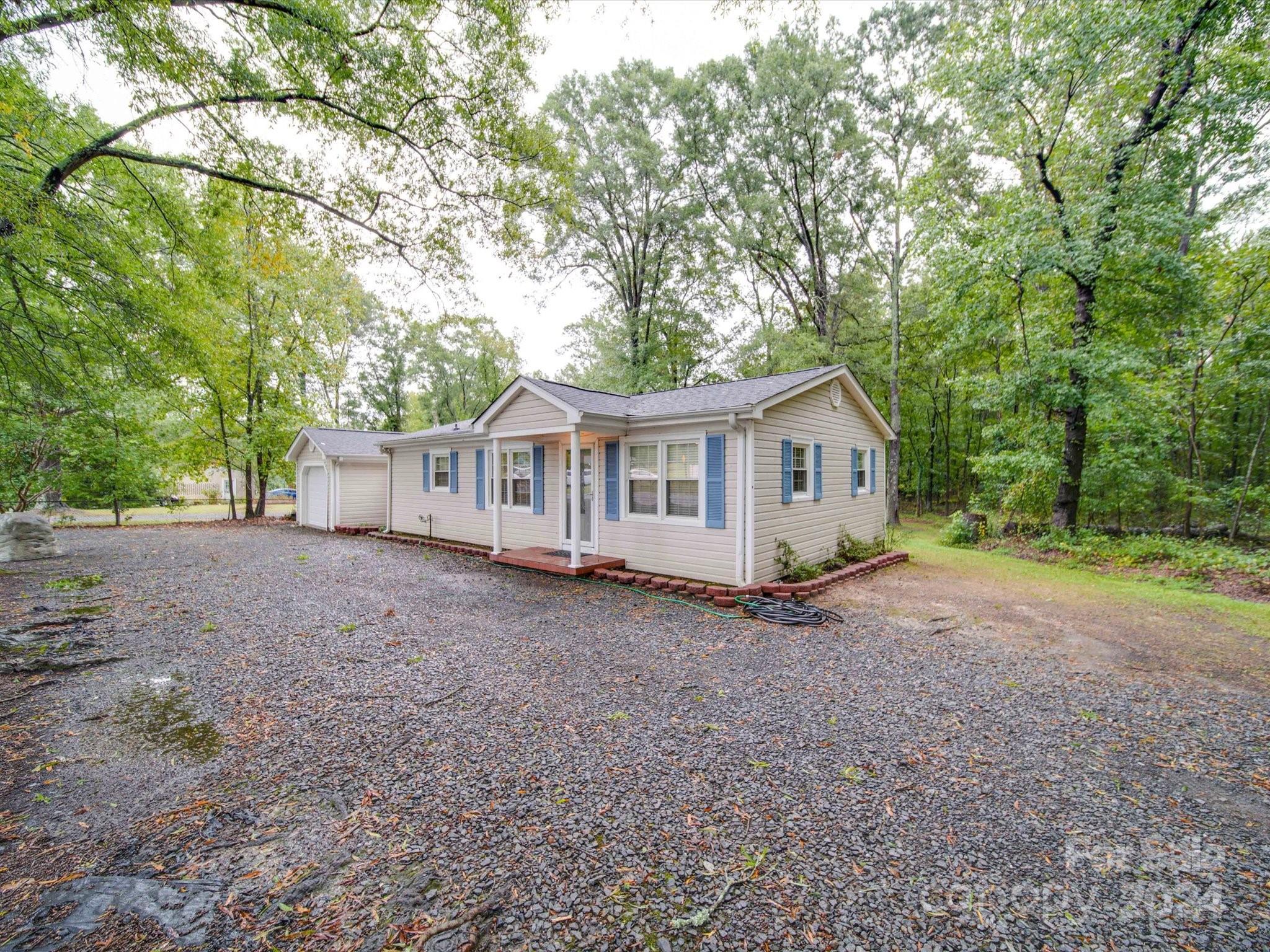 20082 Coley Store Road Locust, NC 28097 - Photo 4 of 43 a view of house with a yard and large trees