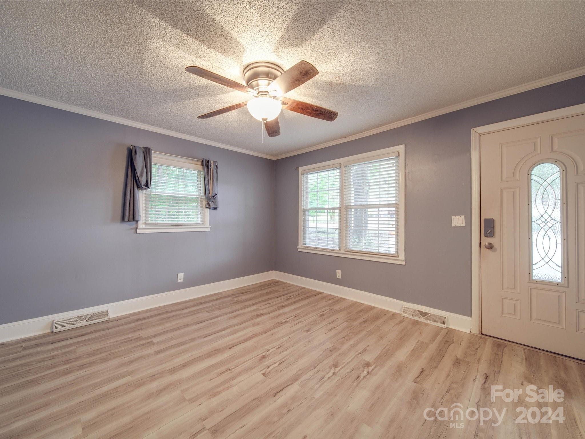 20082 Coley Store Road Locust, NC 28097 - Photo 5 of 43 a view of an empty room with wooden floor and a window