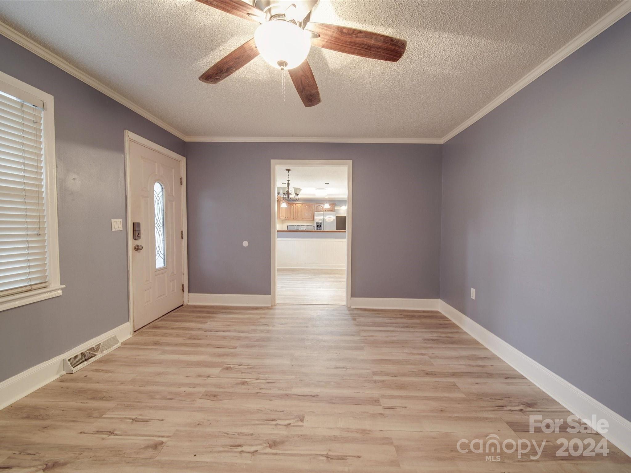20082 Coley Store Road Locust, NC 28097 - Photo 6 of 43 an empty room with wooden floor and windows