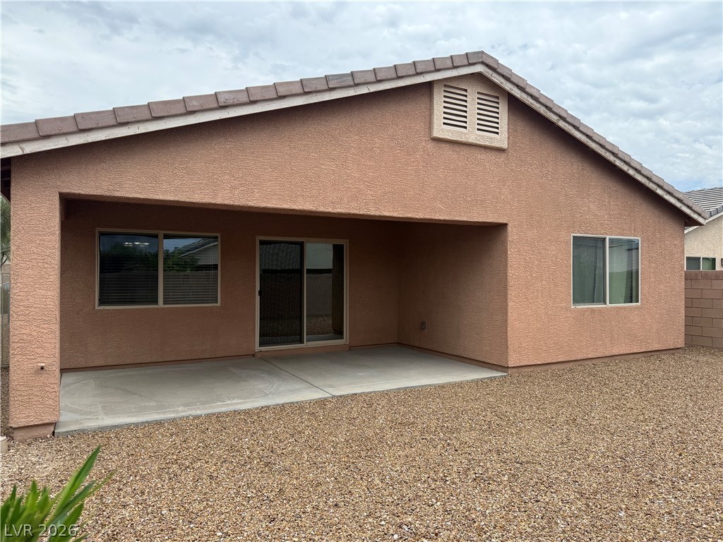 8231 Buffalo Ranch Avenue Las Vegas, NV 89147 - Photo 20 of 22 A private backyard oasis with a covered patio, perfect for enjoying tranquil moments.