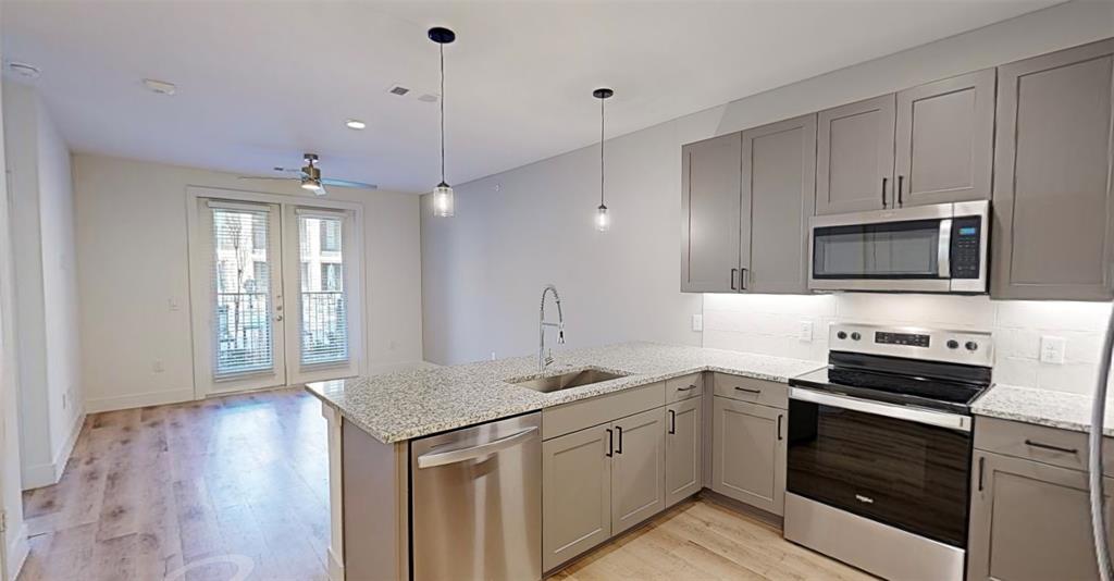 a kitchen with a sink stove and microwave