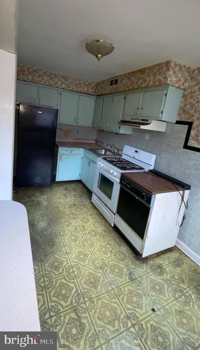 3042 Fairfield Street Philadelphia, PA 19136 - Photo 6 of 23 a kitchen with stainless steel appliances granite countertop a stove a sink and a microwave