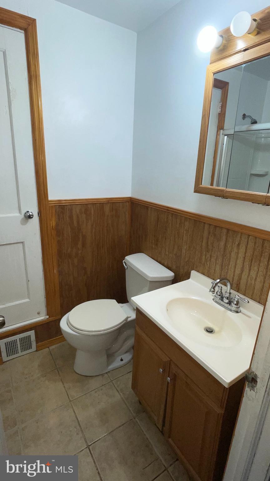 3042 Fairfield Street Philadelphia, PA 19136 - Photo 9 of 23 a bathroom with a sink a toilet and a mirror