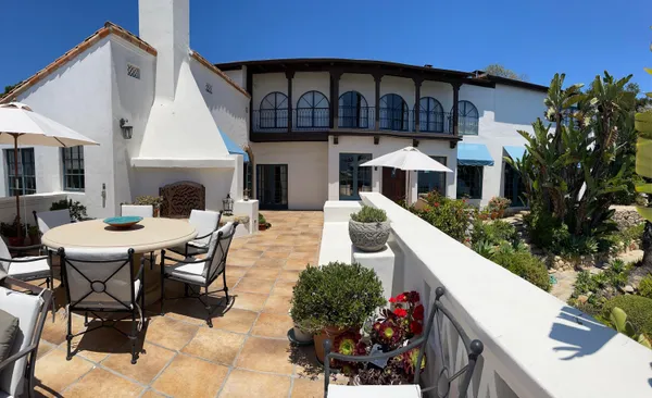 a front view of house with yard outdoor seating and barbeque oven