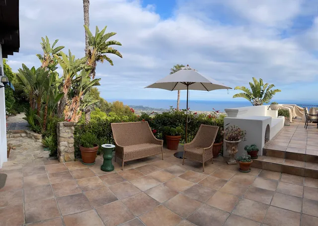 a view of a dining room with furniture and flower pot