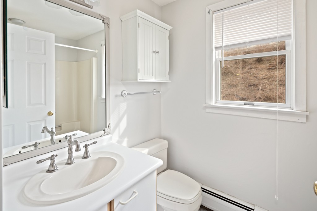 2 Marina Drive, Unit 2 Hull, MA 02045 - Photo 18 of 30 a bathroom with a sink a toilet and a mirror
