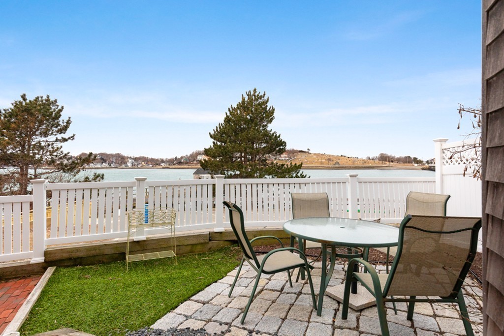 2 Marina Drive, Unit 2 Hull, MA 02045 - Photo 6 of 30 a view of a chairs and table on the lake