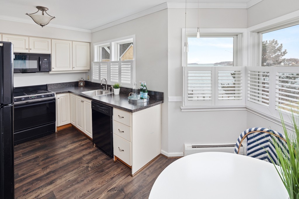 2 Marina Drive, Unit 2 Hull, MA 02045 - Photo 9 of 30 a kitchen with a stove a sink and a microwave