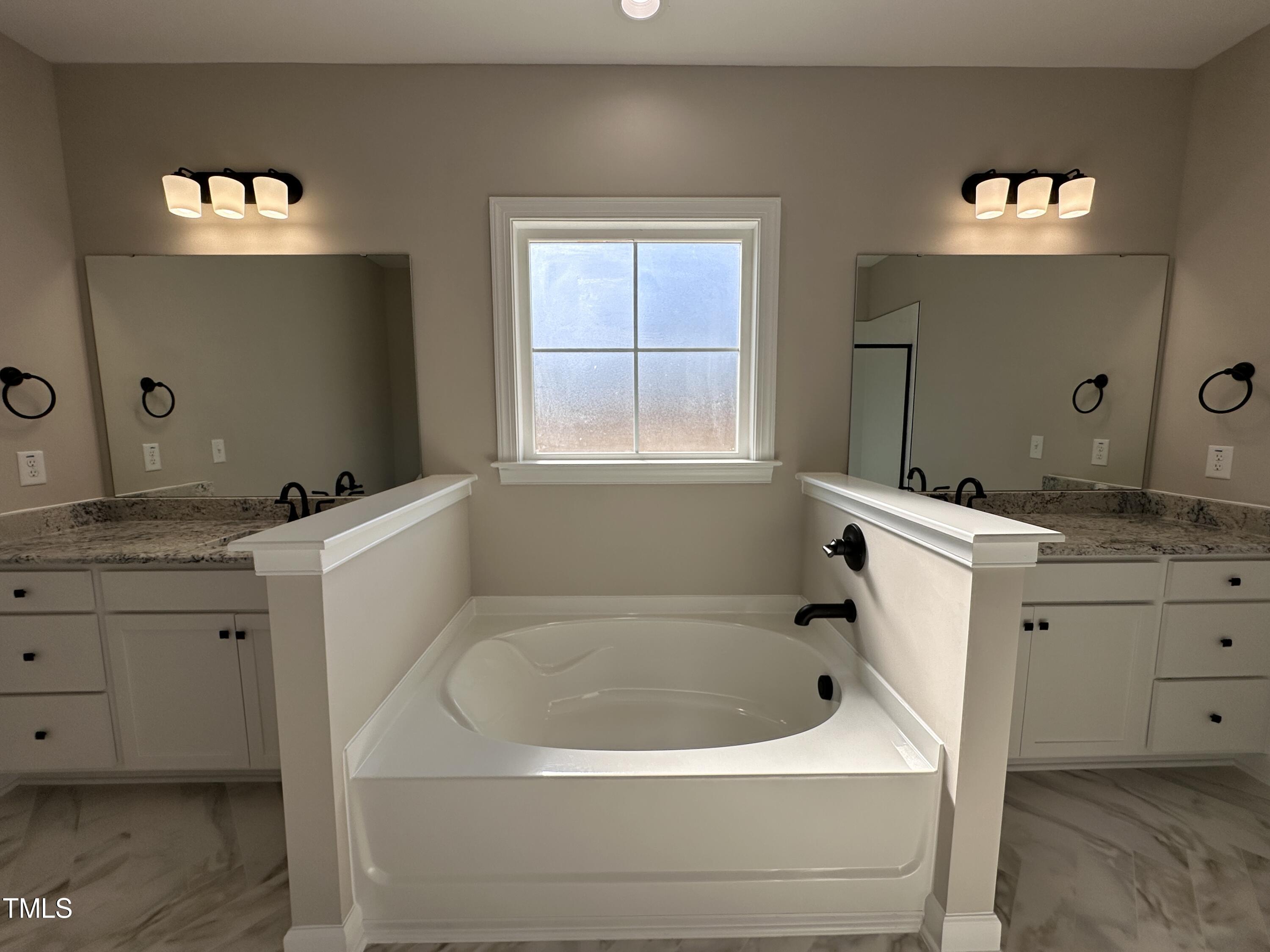 180 Pepperdam Street Smithfield, NC 27577 - Photo 5 of 8 a bathroom with a bathtub sink and mirror