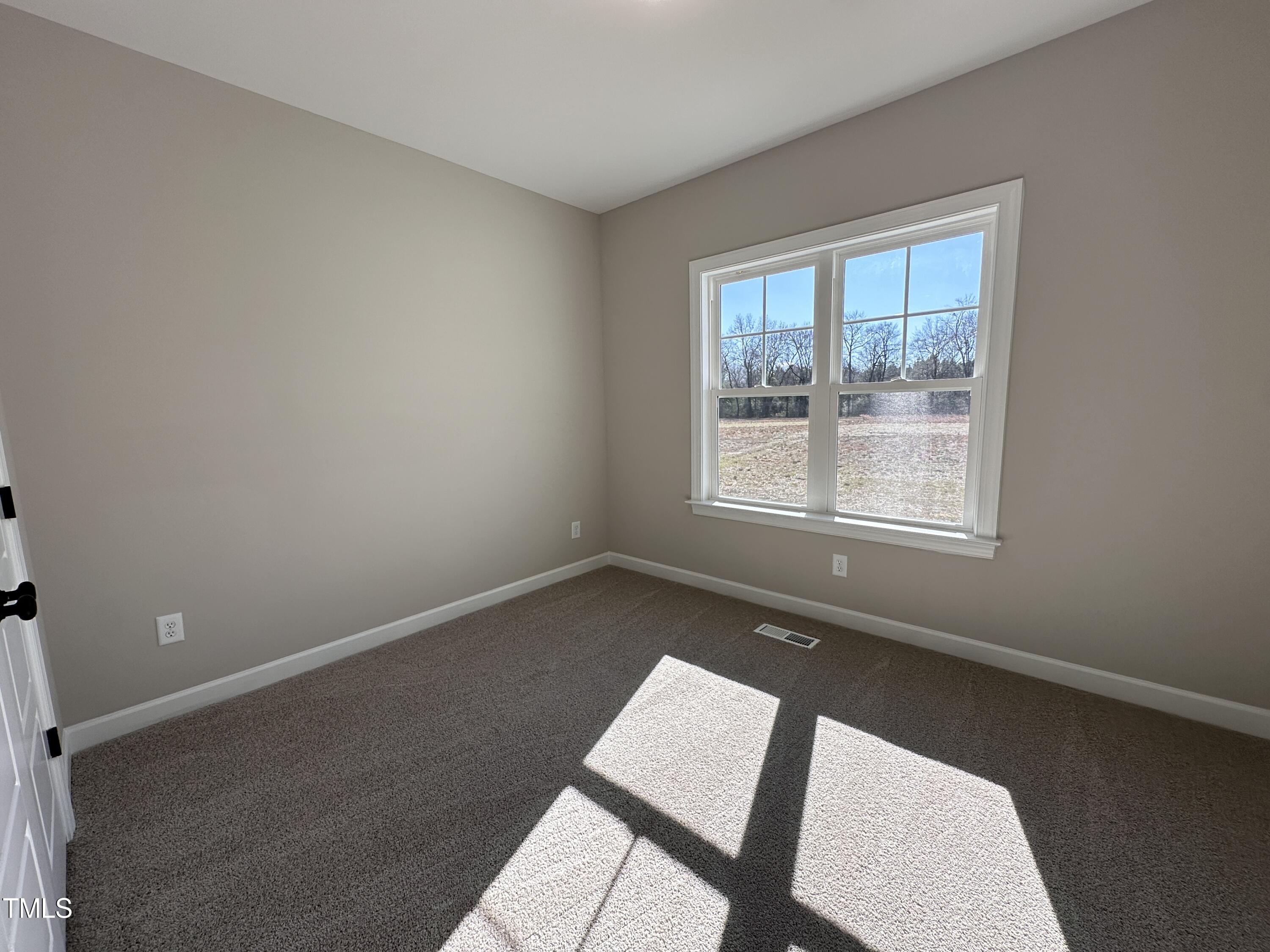 180 Pepperdam Street Smithfield, NC 27577 - Photo 6 of 8 an empty room with windows