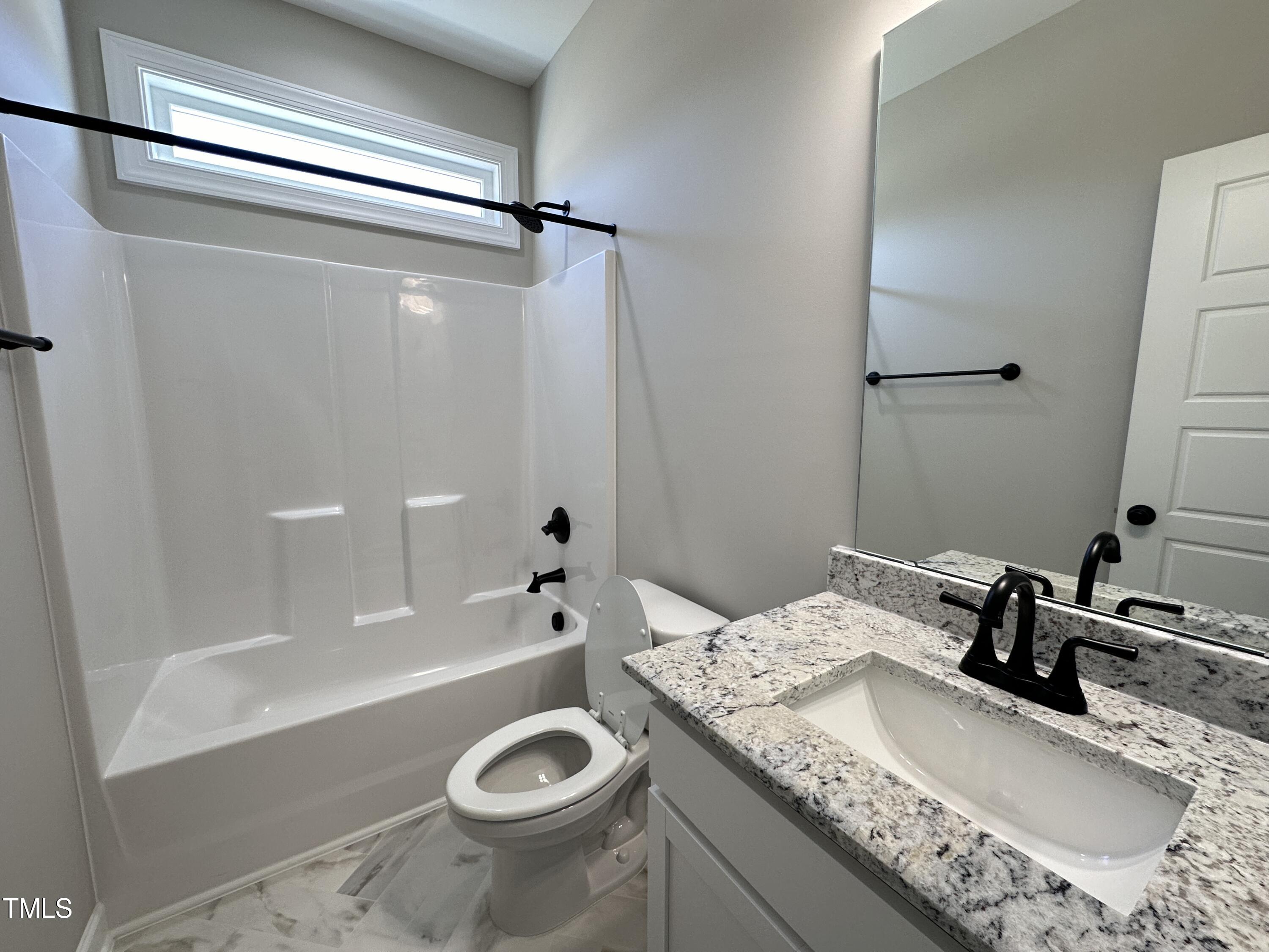 180 Pepperdam Street Smithfield, NC 27577 - Photo 7 of 8 a bathroom with a granite countertop sink toilet and shower
