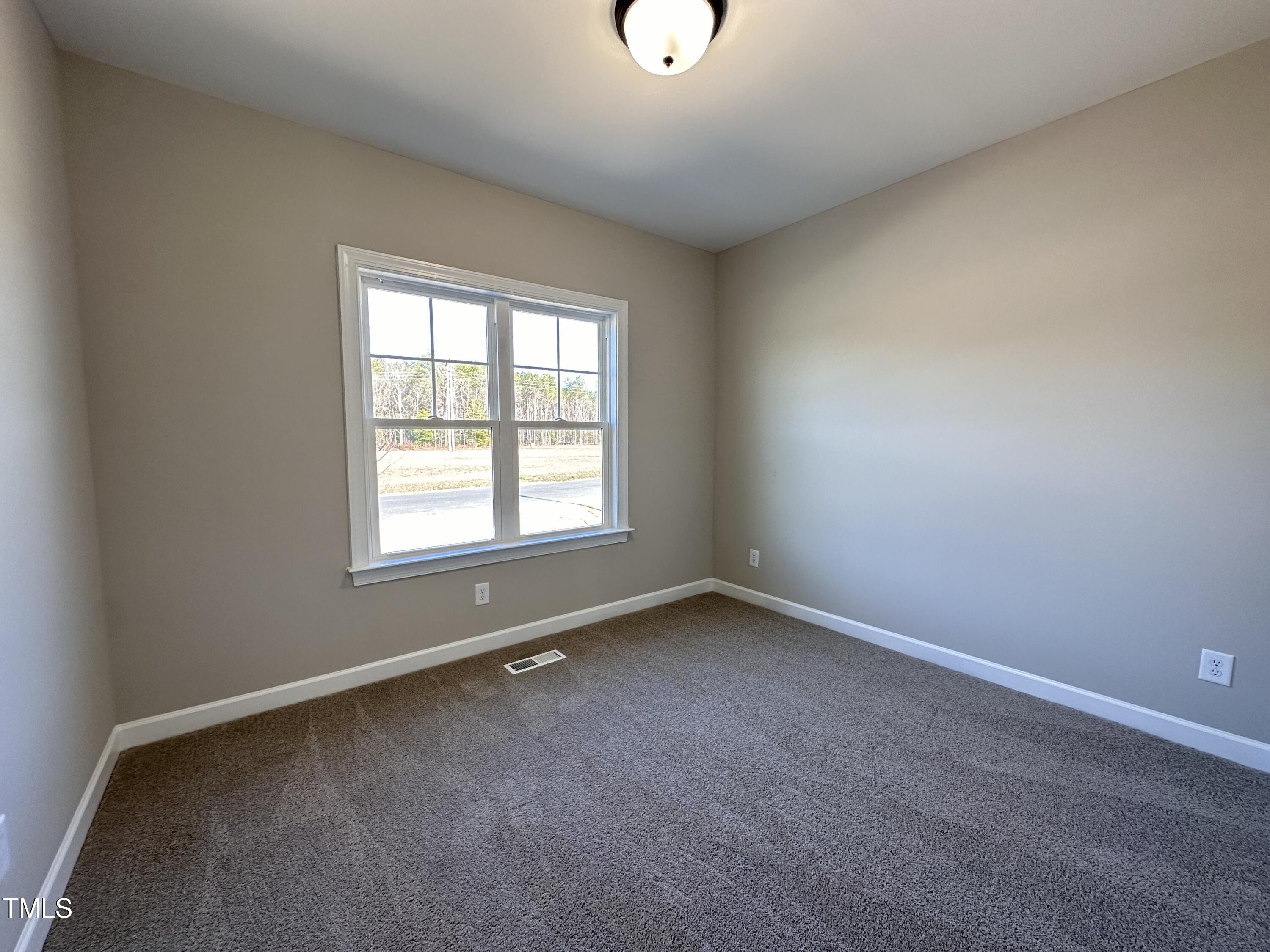 180 Pepperdam Street Smithfield, NC 27577 - Photo 8 of 8 an empty room with a window