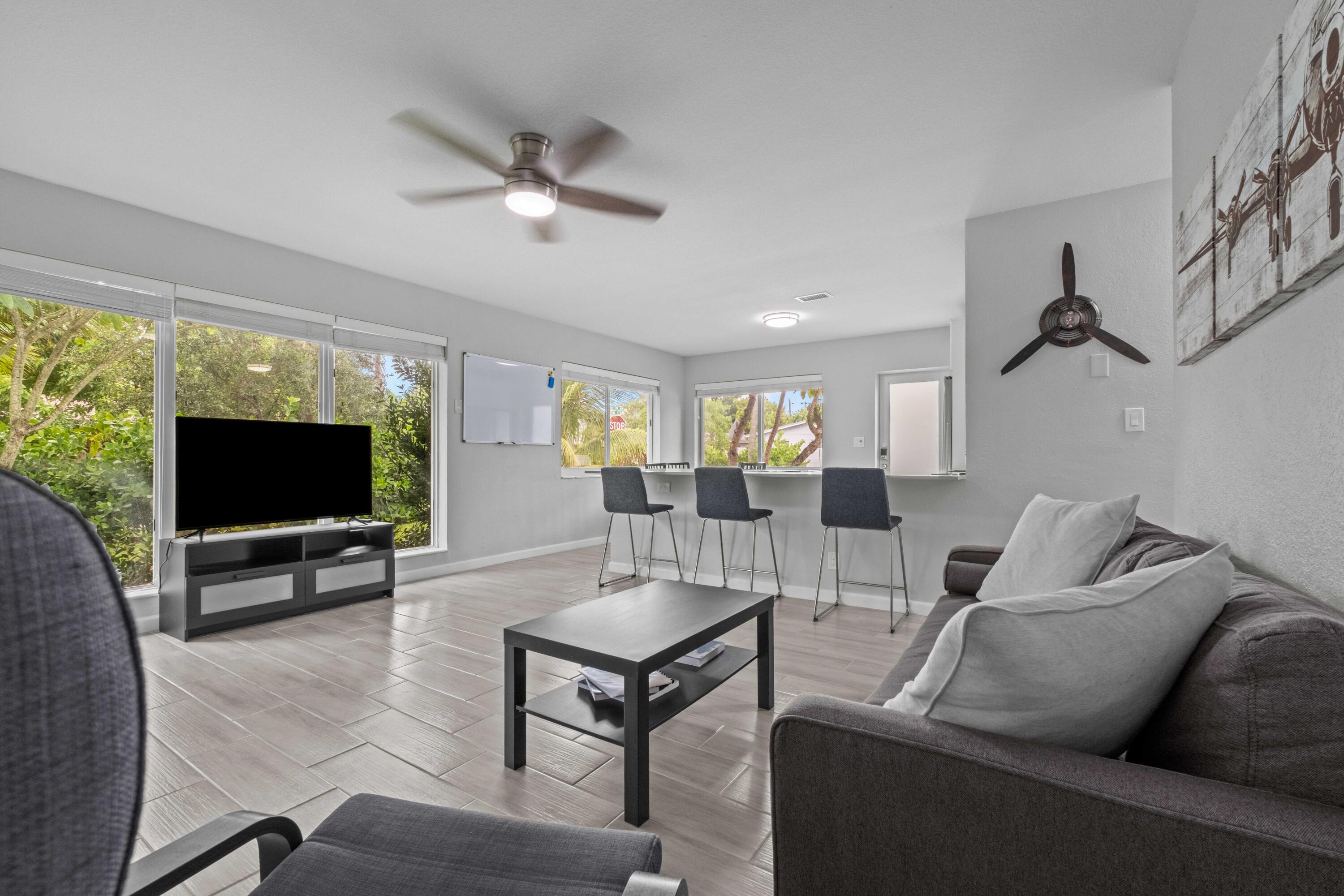 1007 Northeast 9th Court Pompano Beach, FL 33060 - Photo 1 of 21 a living room with furniture and a flat screen tv