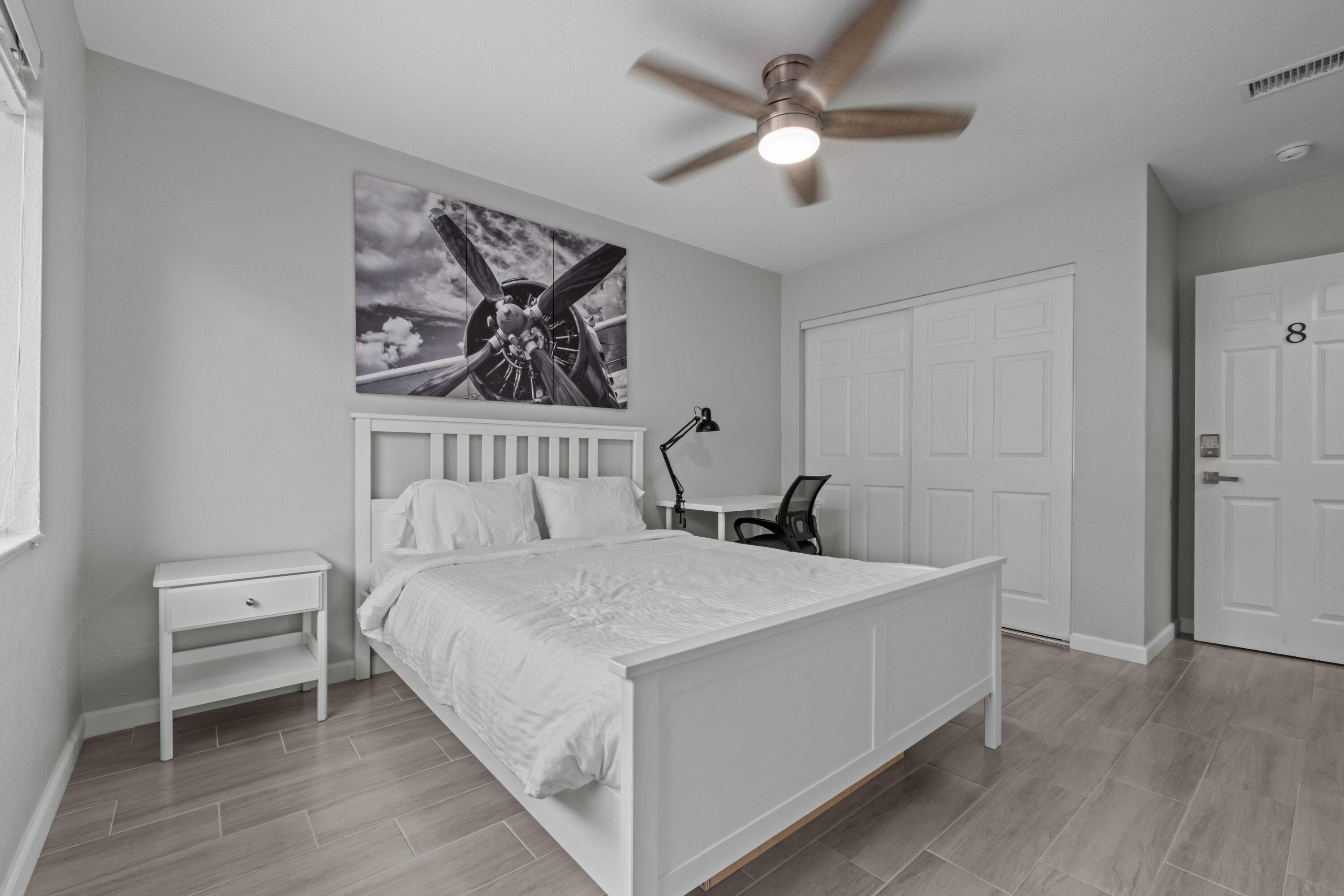 1007 Northeast 9th Court Pompano Beach, FL 33060 - Photo 12 of 21 a bedroom with a bed and a chandelier