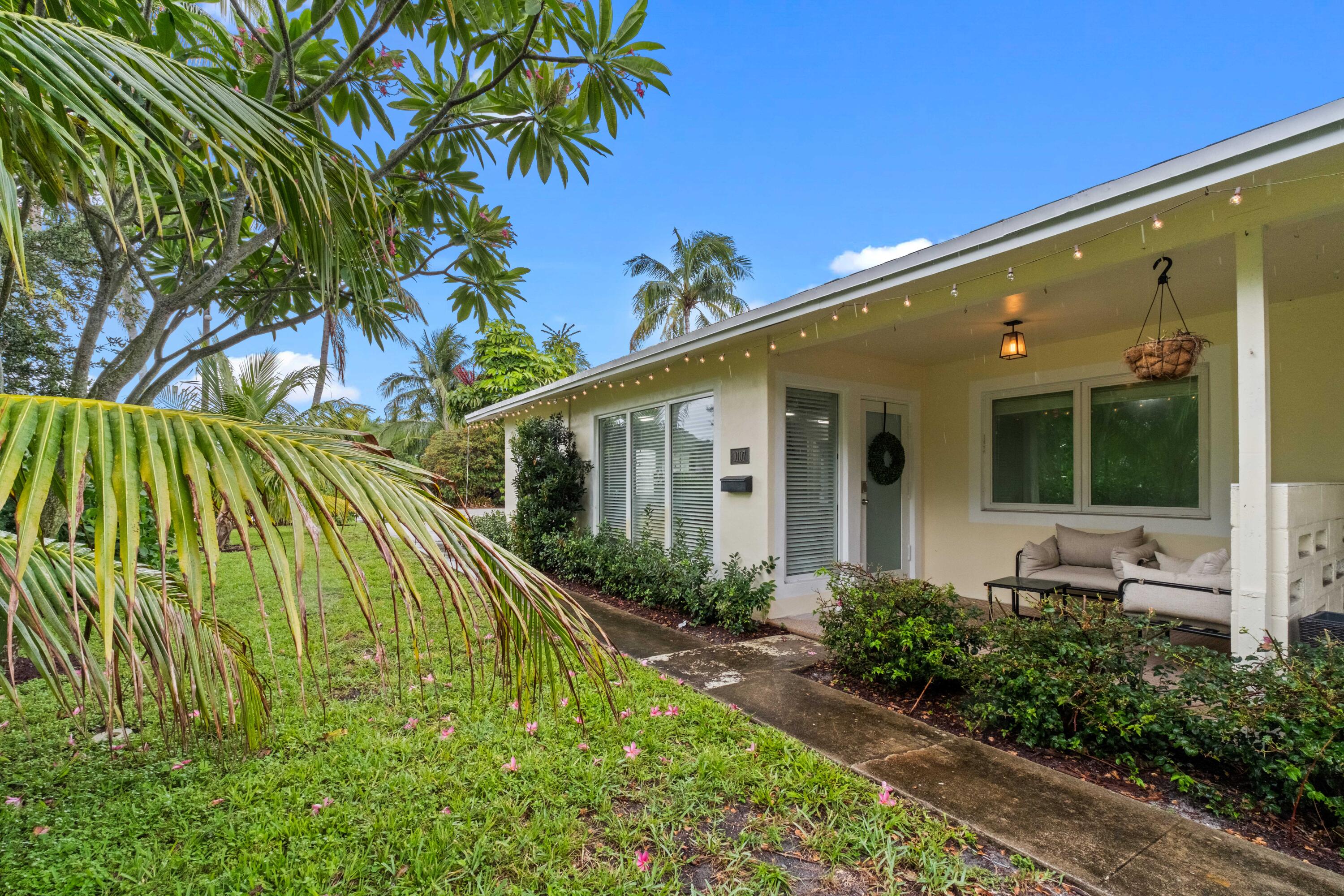 1007 Northeast 9th Court Pompano Beach, FL 33060 - Photo 19 of 21 a front view of a house with a yard