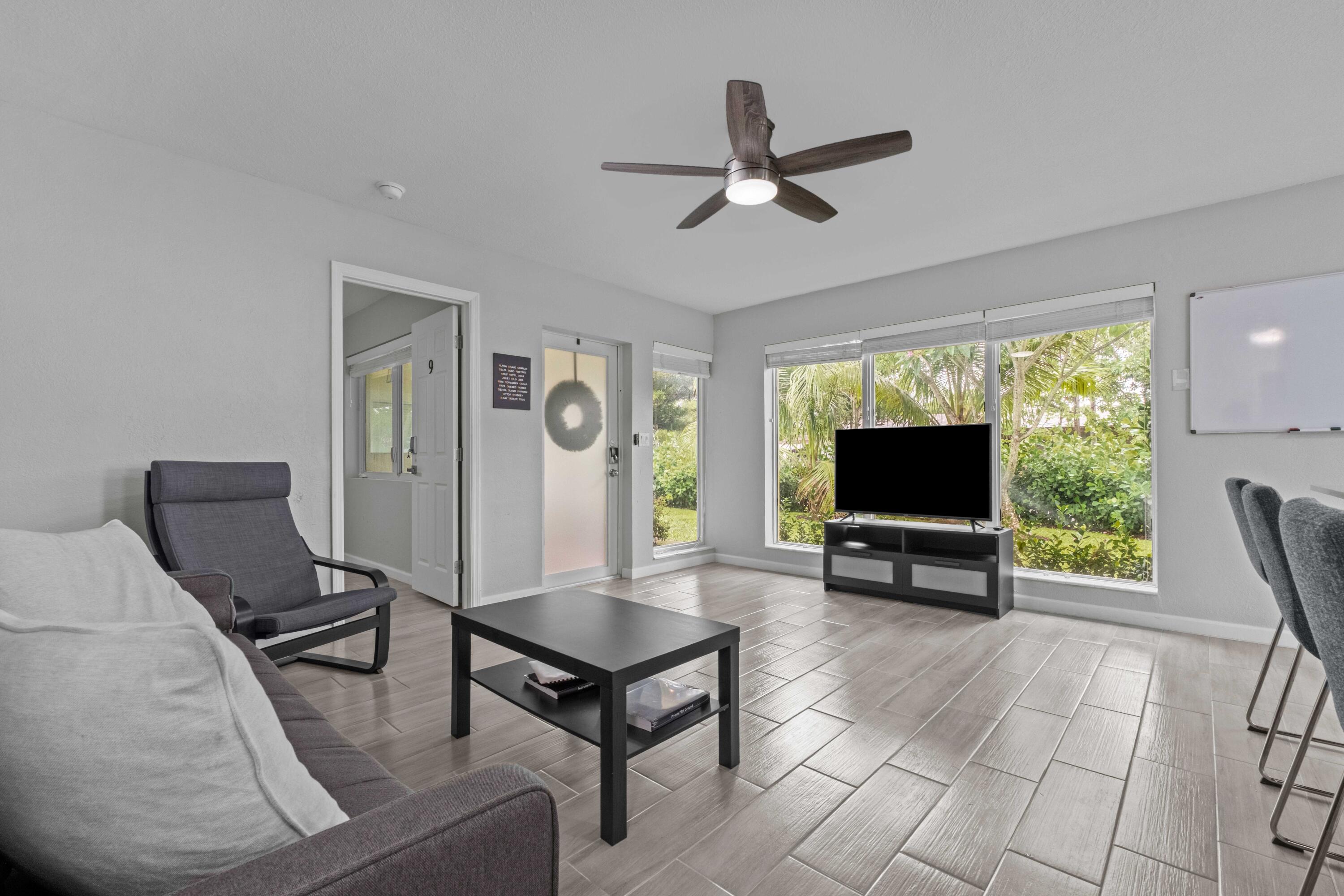 1007 Northeast 9th Court Pompano Beach, FL 33060 - Photo 2 of 21 a living room with furniture and a flat screen tv