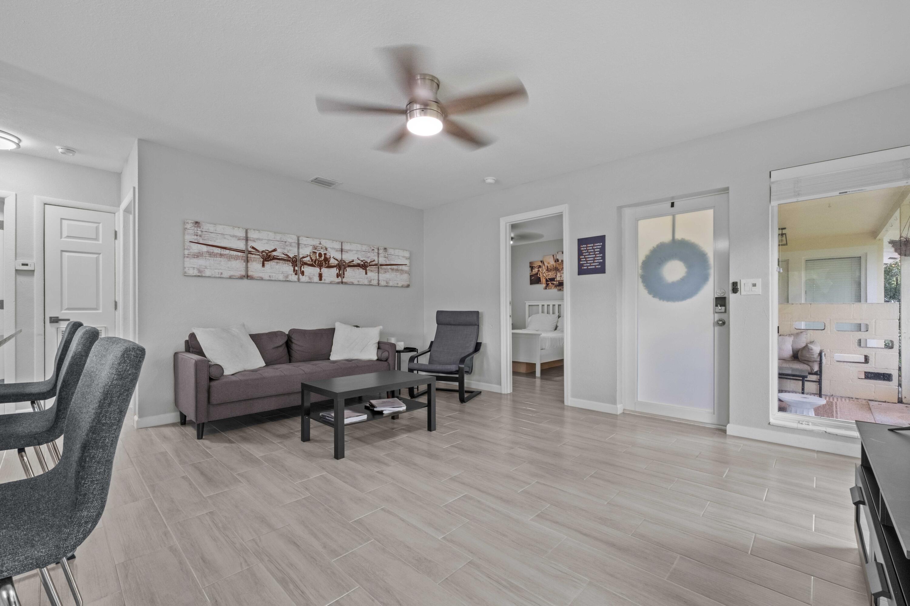 1007 Northeast 9th Court Pompano Beach, FL 33060 - Photo 3 of 21 a living room with furniture and wooden floor