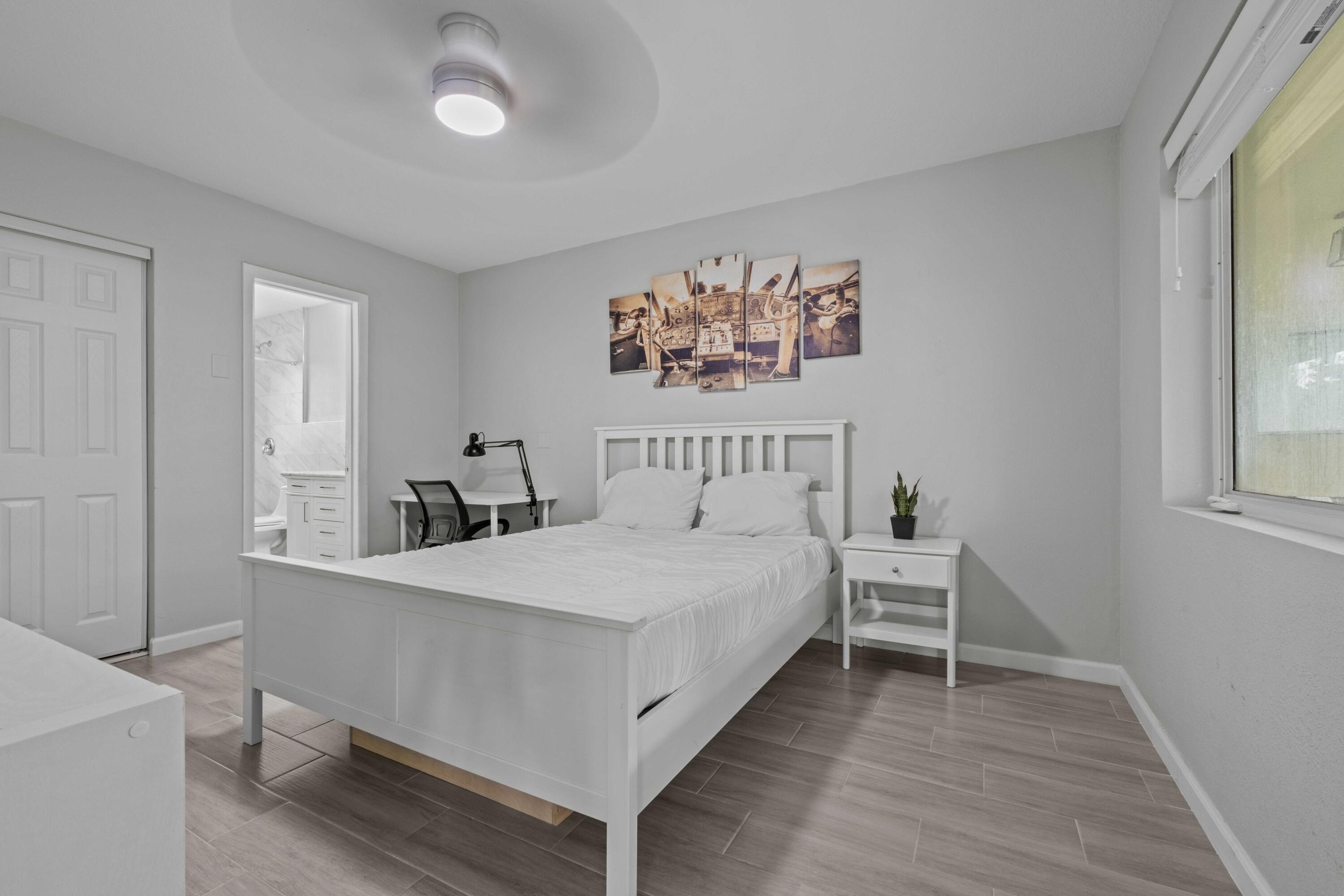 1007 Northeast 9th Court Pompano Beach, FL 33060 - Photo 8 of 21 a bedroom with a bed and a table