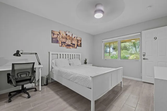 a bedroom with a bed and a window