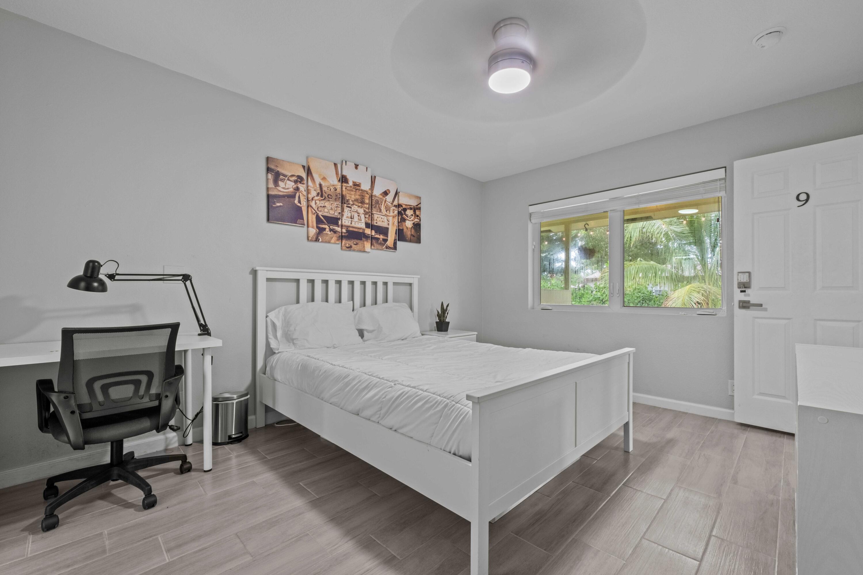 1007 Northeast 9th Court Pompano Beach, FL 33060 - Photo 9 of 21 a bedroom with a bed and a window