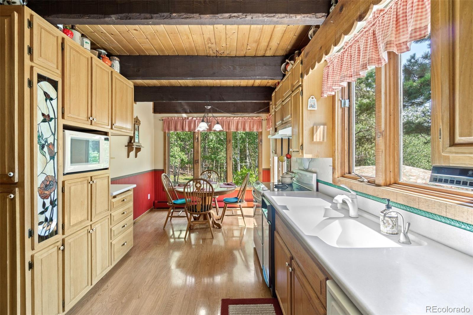 600 Old Squaw Pass Road Evergreen, CO 80439 - Photo 12 of 40 a very nice looking dining room with a large window and chandelier