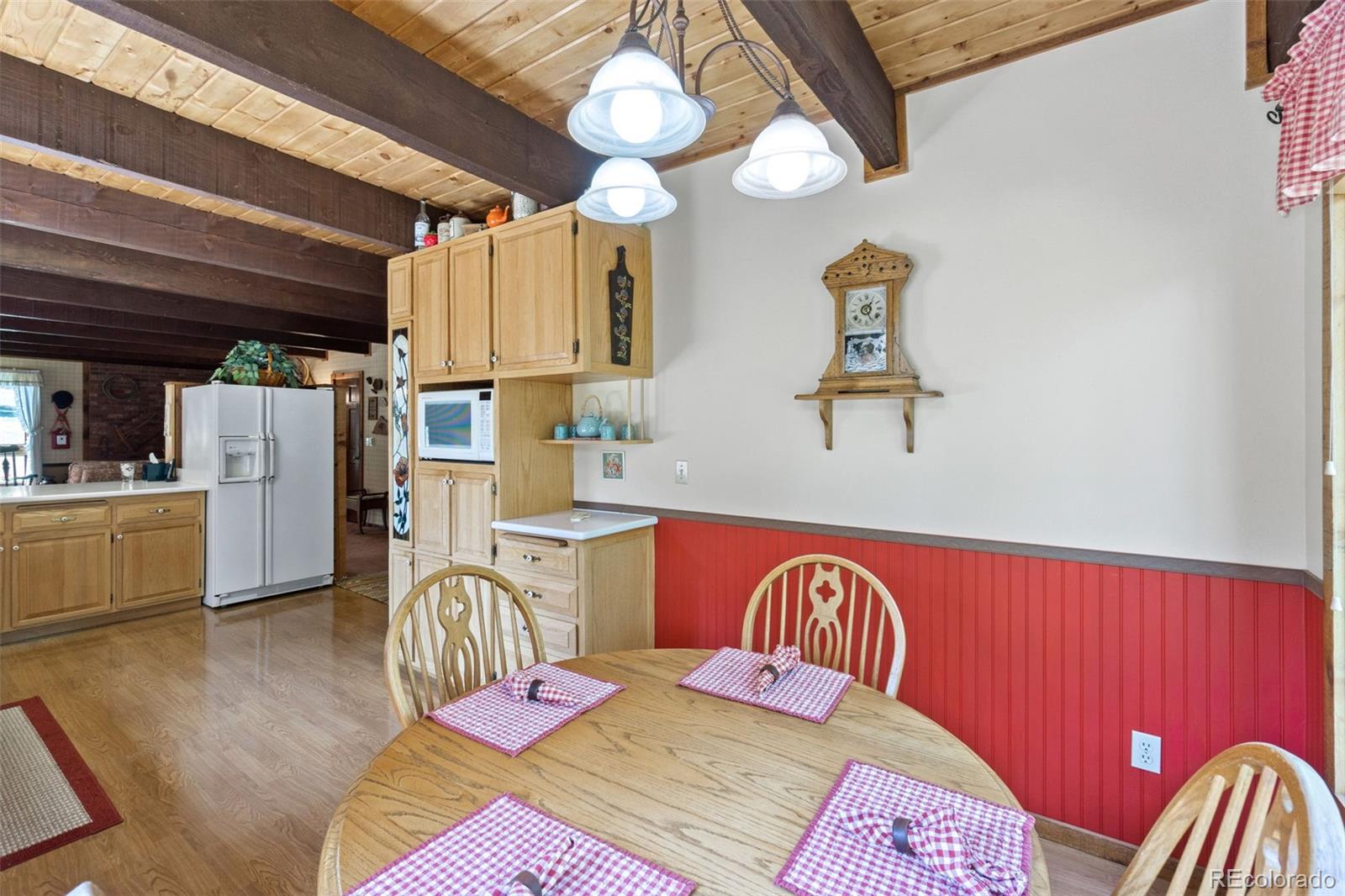 600 Old Squaw Pass Road Evergreen, CO 80439 - Photo 14 of 40 a bedroom with a bed closet and flat screen tv