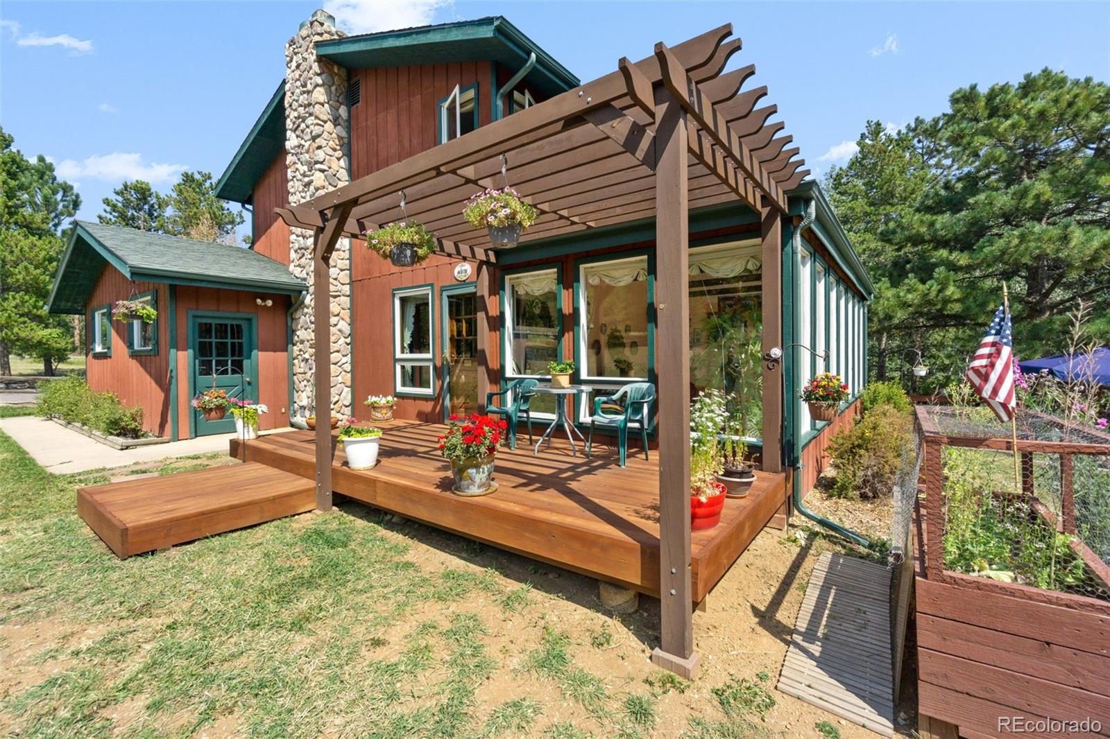 600 Old Squaw Pass Road Evergreen, CO 80439 - Photo 17 of 40 a view of a house with backyard porch and sitting area