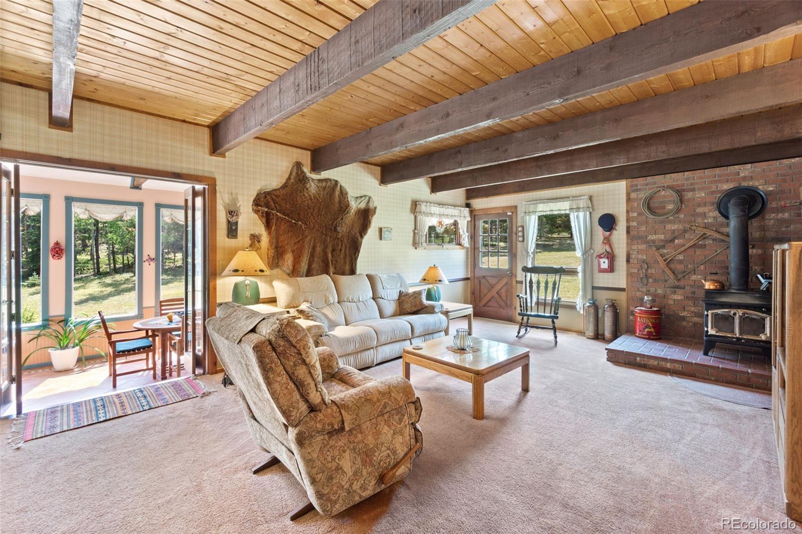 600 Old Squaw Pass Road Evergreen, CO 80439 - Photo 18 of 40 a living room with furniture and a large window