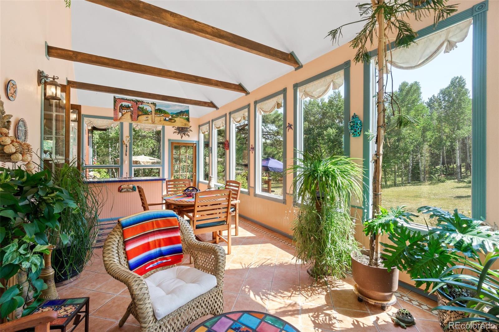 600 Old Squaw Pass Road Evergreen, CO 80439 - Photo 19 of 40 a bedroom with furniture and a potted plant