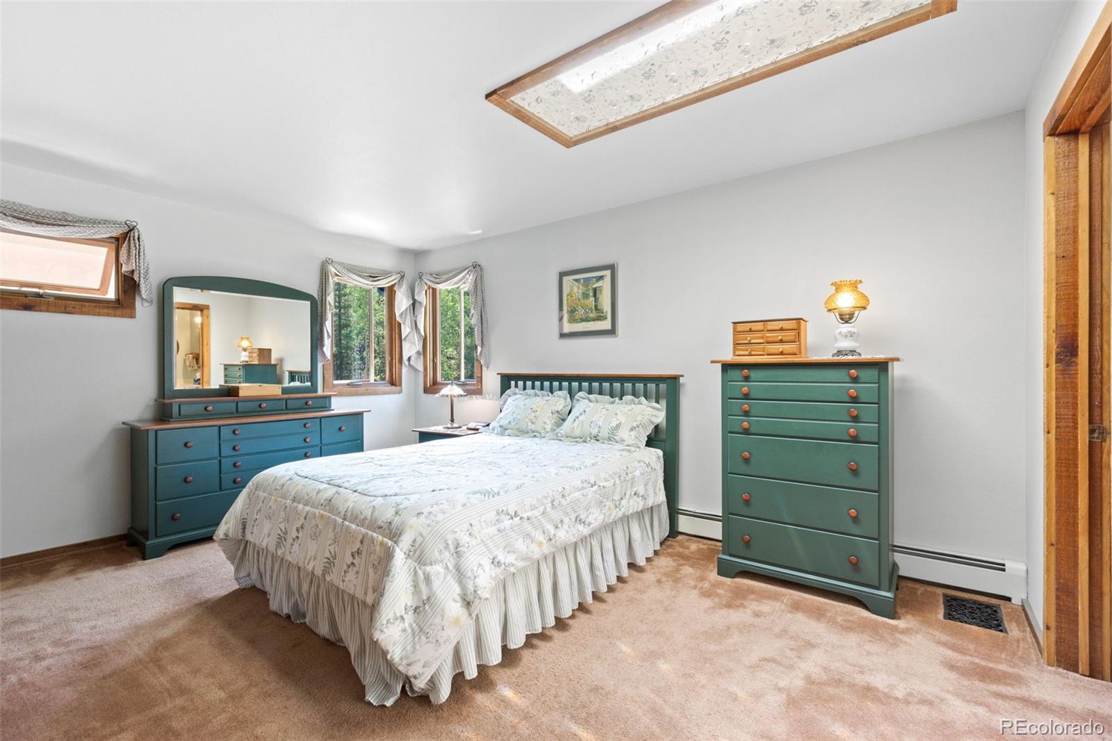 600 Old Squaw Pass Road Evergreen, CO 80439 - Photo 25 of 40 a bedroom with a bed and a dresser