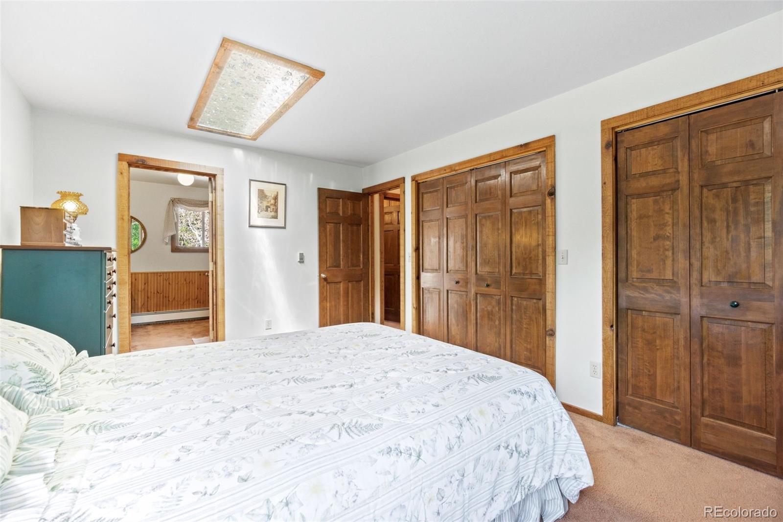 600 Old Squaw Pass Road Evergreen, CO 80439 - Photo 26 of 40 a bedroom with a large bed and a dresser