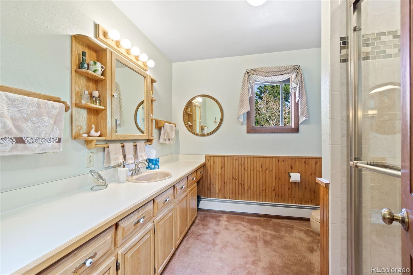 600 Old Squaw Pass Road Evergreen, CO 80439 - Photo 27 of 40 a bathroom with a double vanity sink and a mirror