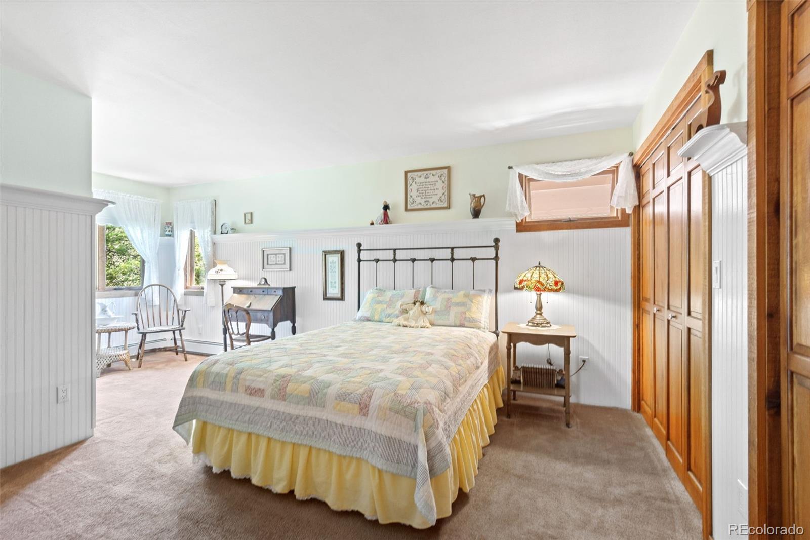 600 Old Squaw Pass Road Evergreen, CO 80439 - Photo 28 of 40 a bedroom with a bed and a table