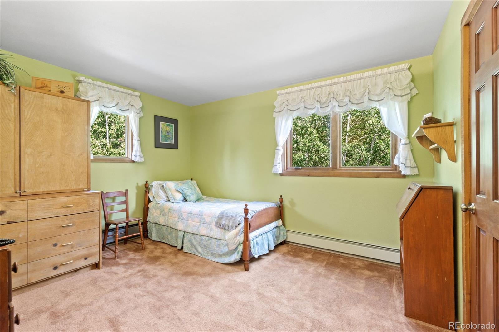 600 Old Squaw Pass Road Evergreen, CO 80439 - Photo 30 of 40 a bedroom with a bed and a window