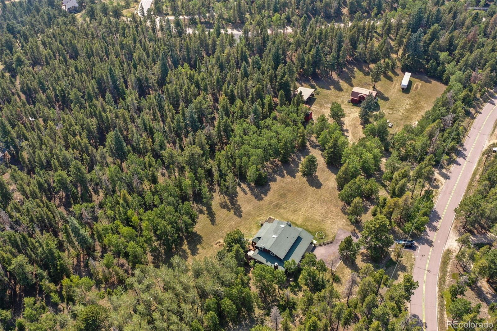 600 Old Squaw Pass Road Evergreen, CO 80439 - Photo 38 of 40 an aerial view of residential house with parking space