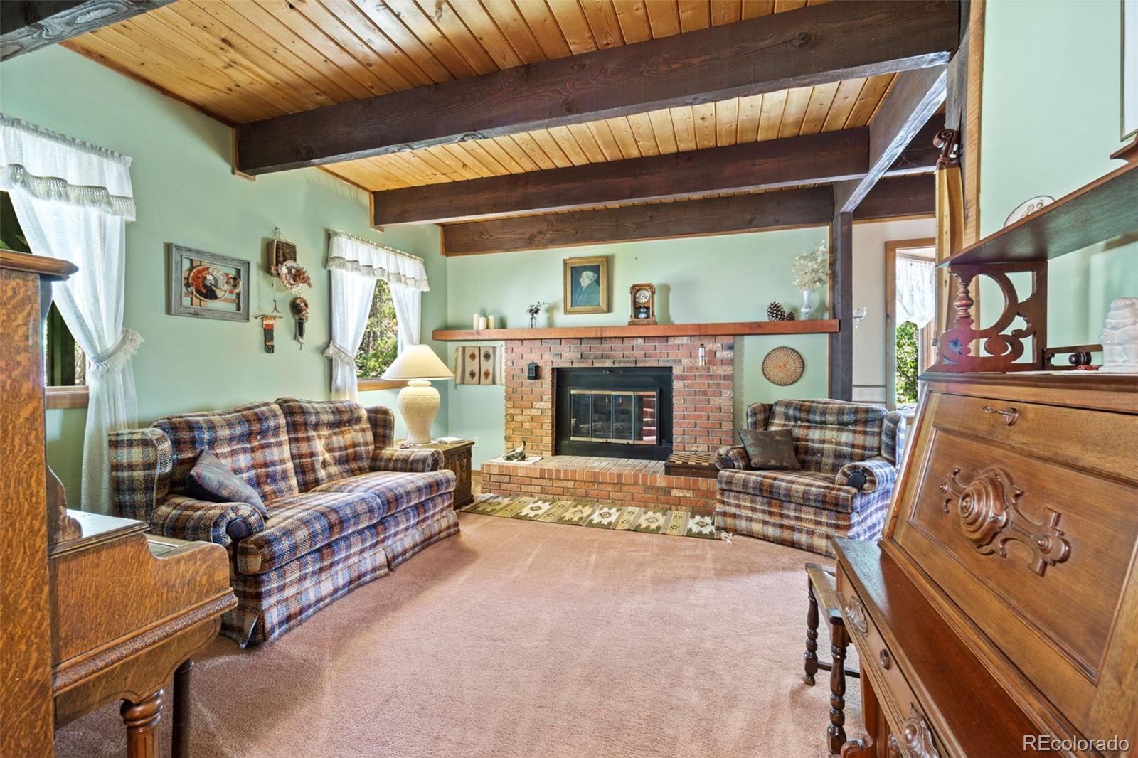 600 Old Squaw Pass Road Evergreen, CO 80439 - Photo 5 of 40 a living room with furniture and a fireplace
