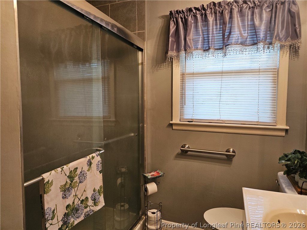 4547 Legion Road Hope Mills, NC 28348 - Photo 15 of 28 a bathroom with a sink and toilet