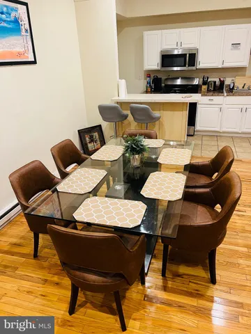 a view of a dining room with furniture and wooden floor