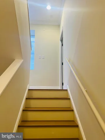 a bedroom with a bed a couch and a flat screen tv