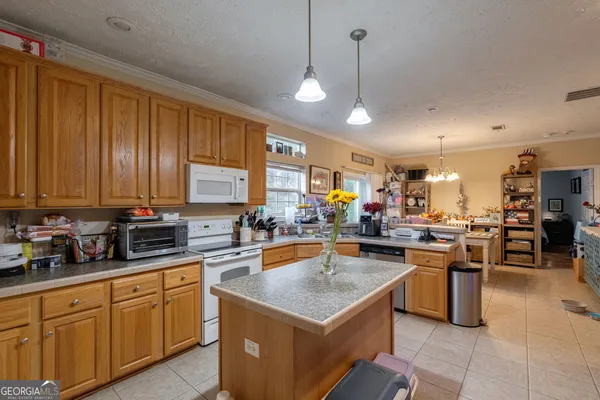 a bed room with a bed and paintings on the wall