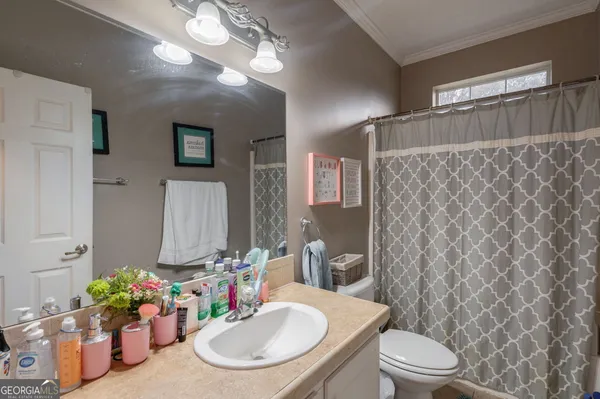 a bathroom with a double vanity sink mirror and a bathtub