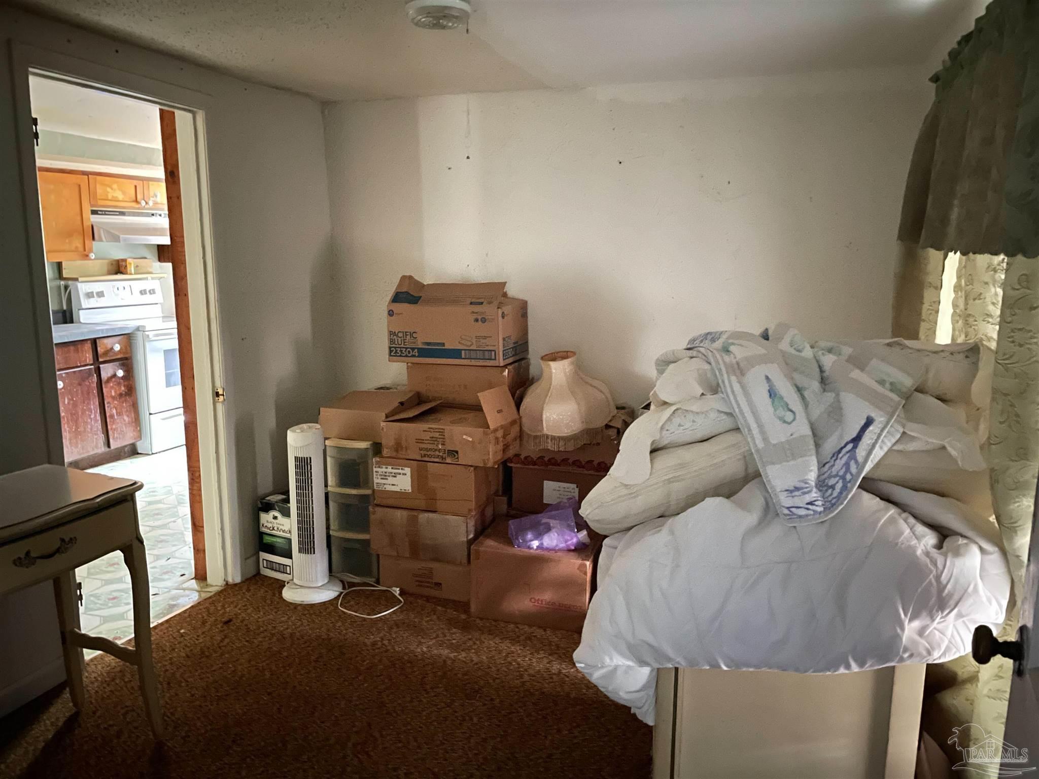 451 East Cane Avenue Crestview, FL 32539 - Photo 12 of 22 a bed sitting in a bedroom next to a window