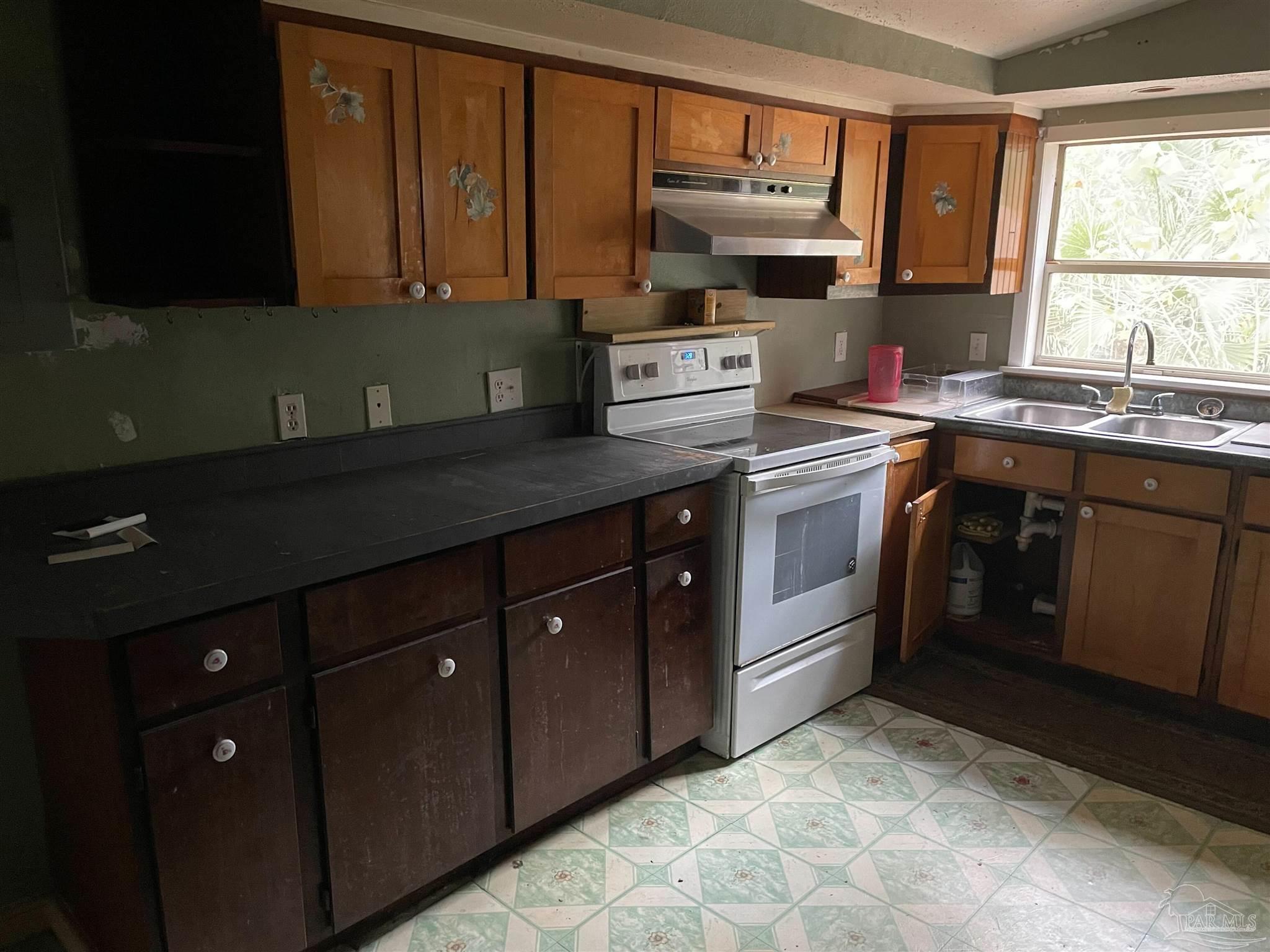 451 East Cane Avenue Crestview, FL 32539 - Photo 14 of 22 a kitchen with stainless steel appliances granite countertop a sink stove and cabinets